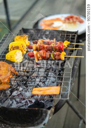 delicious grilled meat with smoke, BBQ with vegetables in outdoor. Barbecue, Party, lifestyle and picnic concept 90780159