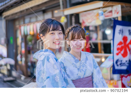 Young women lined up in front of a shaved ice shop 90782194