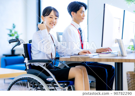 Young woman sitting on wheelchair 90782290