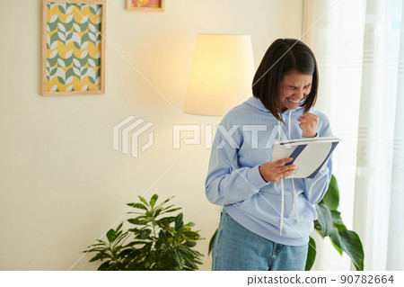 Excited Girl with Acceptance Letter 90782664
