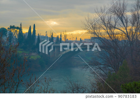 Blazo Jovanovic Bridge over the river Moraca in Podgorica, capital of Montenegro. evening, winter, sunset, dawn 90783183