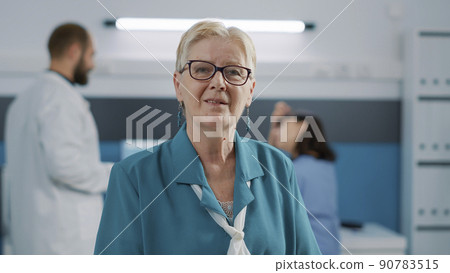 Portrait of senior woman waiting on doctor at checkup appointment, doing examination to receive health care support. Elder patient sitting in medical cabinet for consultation and recovery. Portrait of senior woman waiting on doctor at checkup appointment, doing examination to receive health care support. Elder patient sitting in medical cabinet for consultation and recovery. 90783515