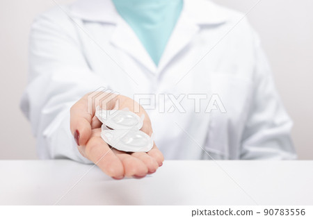 Ophthalmologist holds in his hand container with soft contact lenses for single use. Doctor prescribes use of one-day contact lenses for vision correction. 90783556