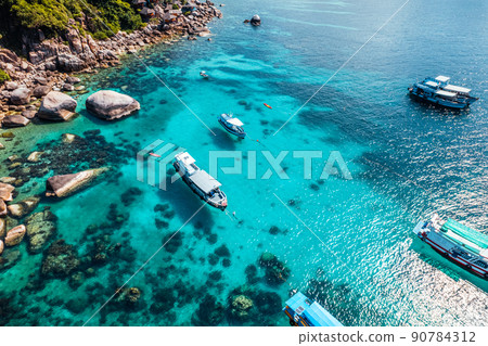 Boats and crystal clear waters at the bay dive site in Koh Tao,diving tour boat 90784312