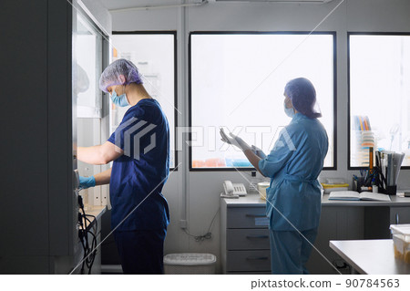 Scientists work in the laboratory. A researcher conducts laboratory research Scientists work in the laboratory. A researcher conducts laboratory research 90784563