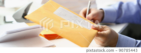 Businessman give envelope to courier for further delivery to address 90785443
