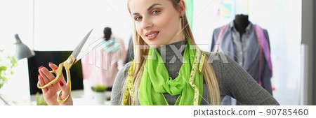 Female successful designer posing with scissors and tape measure on neck 90785460