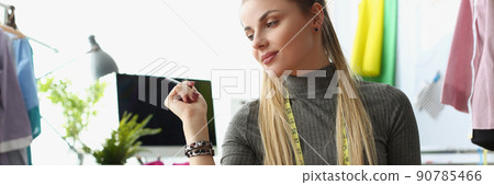 Pensive atelier worker thinking on new idea for collection holding pen 90785466