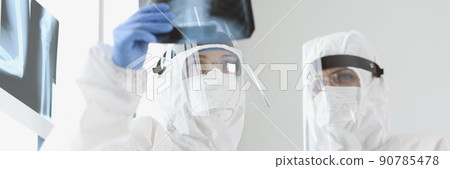 Qualified doctors examine x ray of patients lungs in hospital 90785478