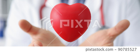 Medical worker throw red plastic heart and catch it in palms 90785527