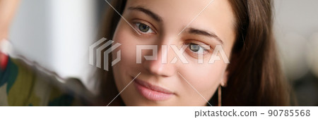 Brunette woman master at beauty salon do haircut with full involvement 90785568