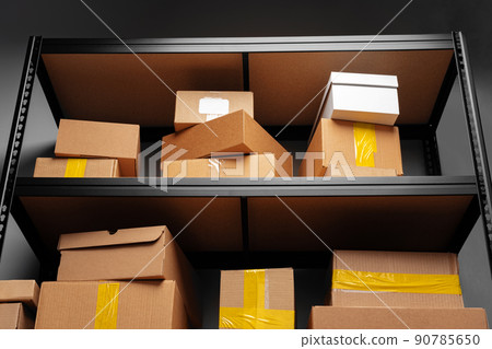 Rows of shelves with cardboard boxes in modern warehouse 90785650
