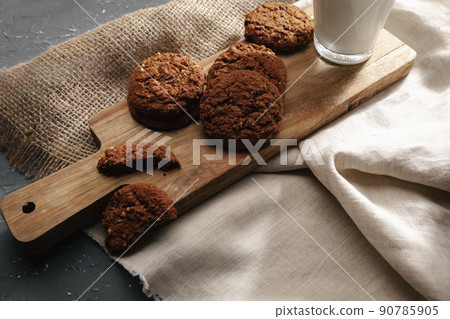Glass of milk and cookies on table Glass of milk and cookies on table 90785905