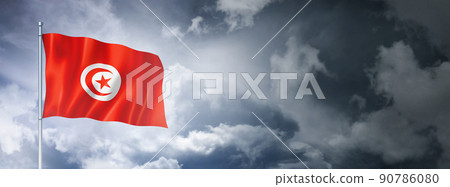 Tunisian flag on a cloudy sky Tunisian flag on a cloudy sky 90786080