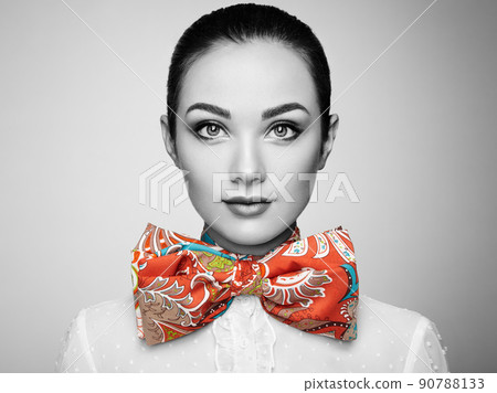 Portrait of beautiful young woman with bow 90788133