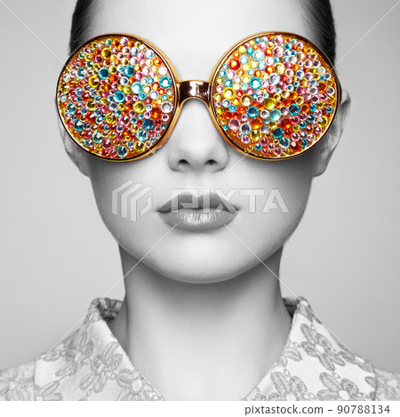 Portrait of beautiful young woman with colored glasses 90788134