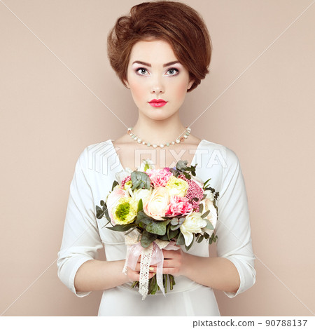 Woman with bouquet of flowers in her hands 90788137