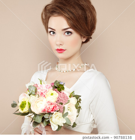 Woman with bouquet of flowers in her hands 90788138