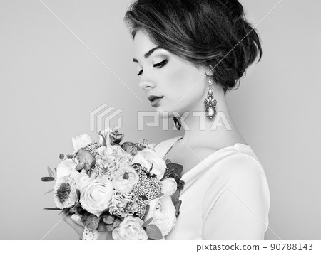 Woman with bouquet of flowers in her hands 90788143