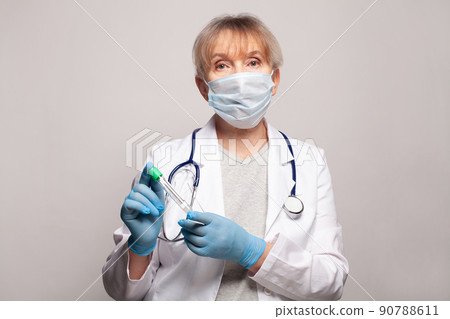 Medical worker in white uniform coat holding test tube 90788611