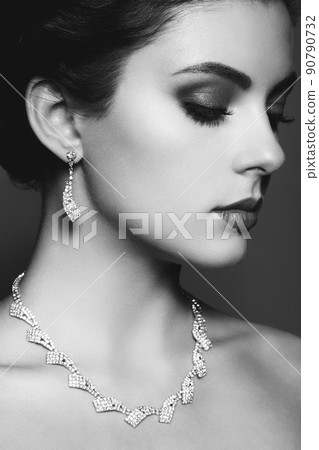 Fashion portrait of young beautiful woman with jewelry. 90790732