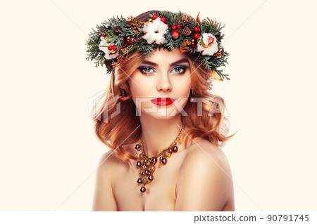 Portrait of beautiful young woman with Christmas wreath Portrait of beautiful young woman with Christmas wreath 90791745