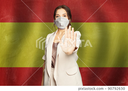 Smart woman in protective mask against flag of Spain banner background 90792630