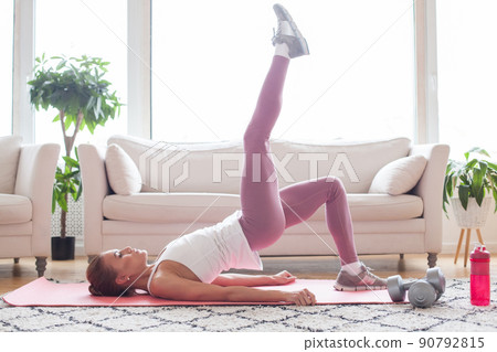 Young sporty woman practicing, doing exercise, working out, wearing sportswear Young sporty woman practicing, doing exercise, working out, wearing sportswear 90792815