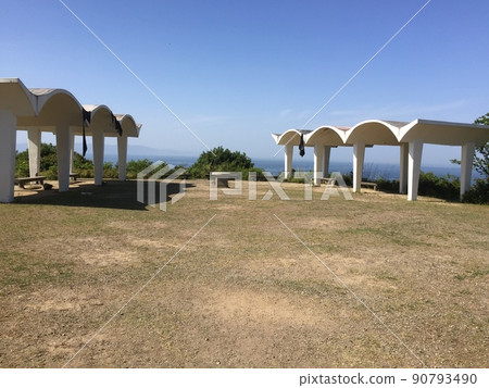 A square with a bench overlooking the big sky and the sea A square with a bench overlooking the big sky and the sea 90793490