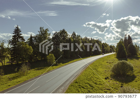 Asphalt road through green hills and clouds in the blue sky. High quality photo 90793677