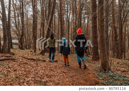 Family hiking in mountains or forest with sport hiking shoes. Family hiking in mountains or forest with sport hiking shoes. 90795116