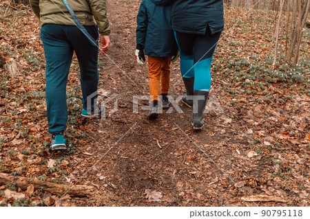 Family hiking in mountains or forest with sport hiking shoes. Family hiking in mountains or forest with sport hiking shoes. 90795118