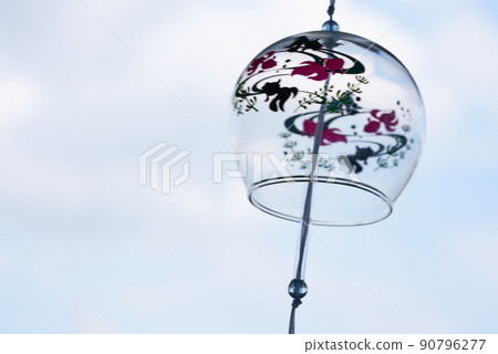 Glass wind chime swaying in the wind h 90796277