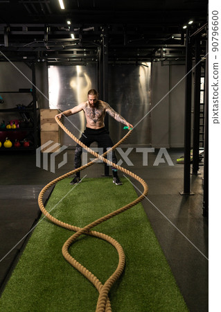 Rope training man warehouse fitness gym muscular exercising exercise workout, concept strong heavy from body from sportsman sport, muscle wave. Standing ground, Rope training man warehouse fitness gym muscular exercising exercise workout, concept strong heavy from body from sportsman sport, muscle wave. Standing ground, 90796600