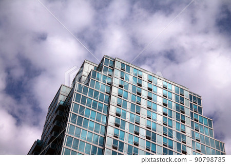 The glass mirror skyscraper which disappear in the blue sky 90798785