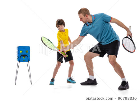 Professional tennis player, instructor and school age boy wearing sports uniform standing together isolated over white background. Concept of sport, achievements, hobby, skills 90798830
