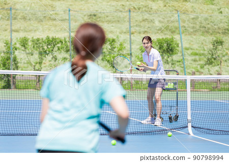 A woman practicing tennis receive 90798994