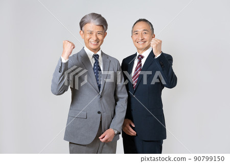 Portrait of two senior men wearing suits and guts poses 90799150