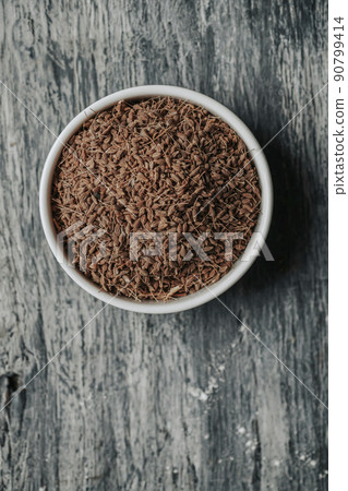 dry anise seeds in a white bowl dry anise seeds in a white bowl 90799414