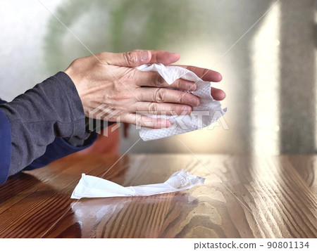 A woman wiping her hands with a paper towel A woman wiping her hands with a paper towel 90801134