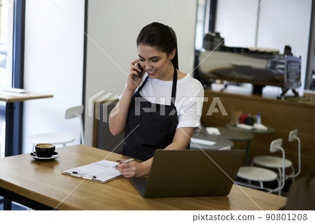 Beautiful woman waitress filling application form checking commercial products Beautiful woman waitress filling application form checking commercial products 90801208