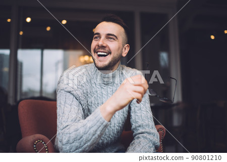 Positive man sitting in armchair Positive man sitting in armchair 90801210