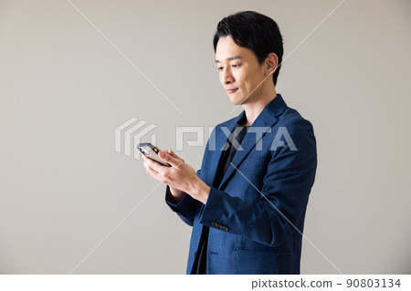 A male with a smartphone A male with a smartphone 90803134