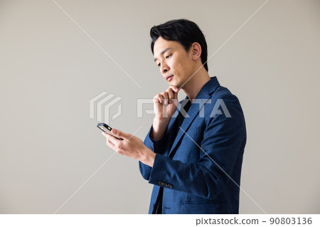 A male with a smartphone 90803136