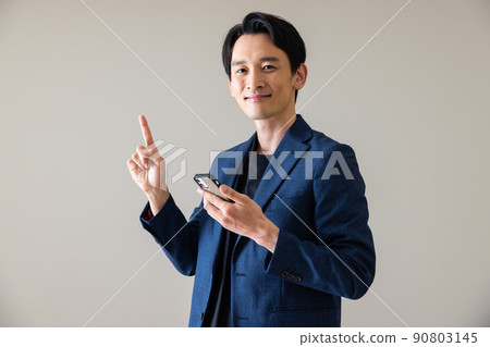 A male with a smartphone A male with a smartphone 90803145