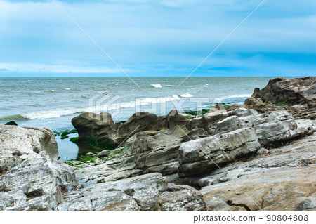 gently sloping rocky shore of the Caspian Sea with rounded rocks and algae on the stones gently sloping rocky shore of the Caspian Sea with rounded rocks and algae on the stones 90804808