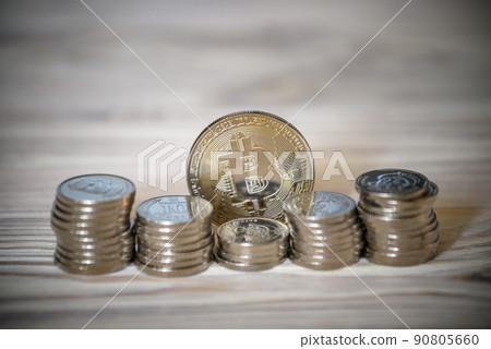 Bitcoin over the ukrainian hryvnia currency. Close up Bitcoin over the ukrainian hryvnia currency. Close up 90805660