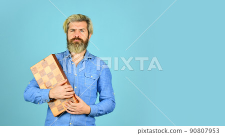 bearded man hold chess board. intelligence quotient. 90807953