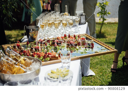 A wide variety of snacks on the table for guests. Shrimp, boiled pork, various types of meat and other products 90808129