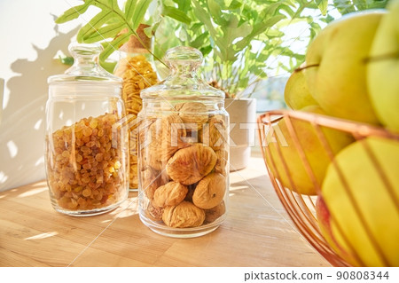 Dry fruits in a jar, figs, raisins, apples. Food storage in the kitchen Dry fruits in a jar, figs, raisins, apples. Food storage in the kitchen 90808344
